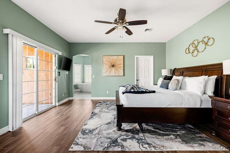 Primary bedroom with TV & direct outdoor access.