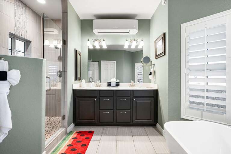 Private en-suite bathroom with dual sinks, modern lighting, and spa-level comfort.
