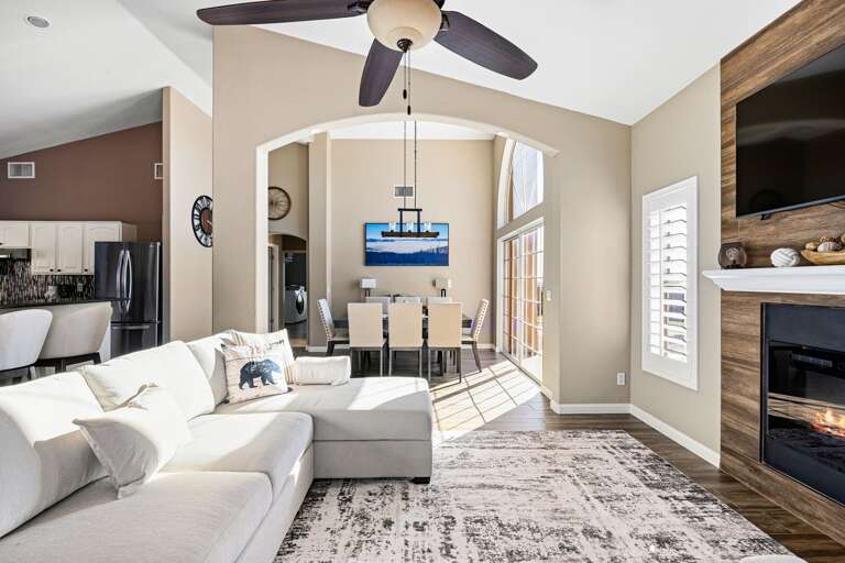 Spacious great room with vaulted ceilings, cozy fireplace, and dining for the whole group.