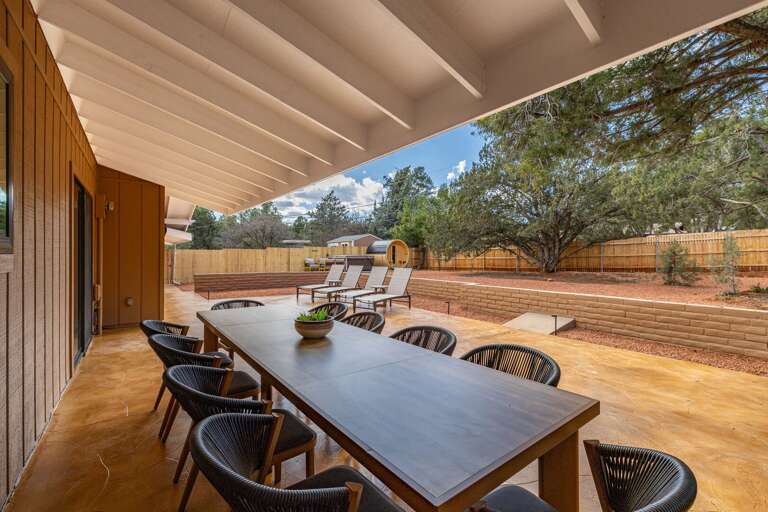 Enjoy meals outdoors on the large covered patio overlooking the relaxing backyard retreat.