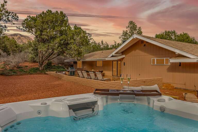 Soak in the hot tub while enjoying stunning sunset views and peaceful desert surroundings.