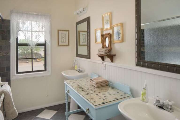 Blue Room: A cozy room with a King-sized bed and beautiful stained-glass windows. It features a