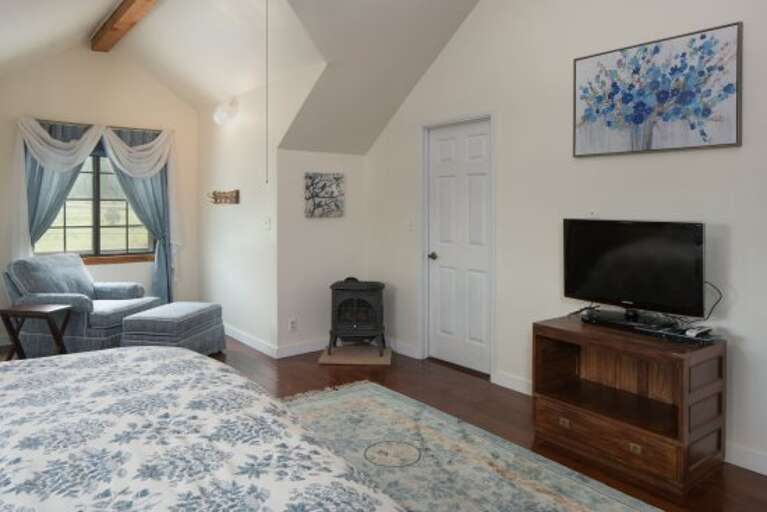 Blue Room: A cozy room with a King-sized bed and beautiful stained-glass windows. It features a