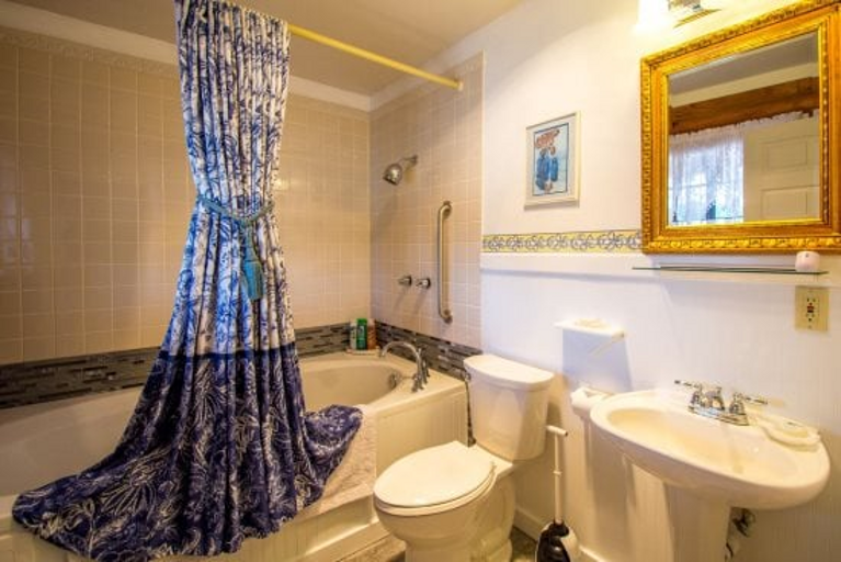 It features a queen bed, private bath with jacuzzi, a fireplace in both the room and lobby, and private access to a wrap-around deck with stunning views of Bill Williams Mountain.