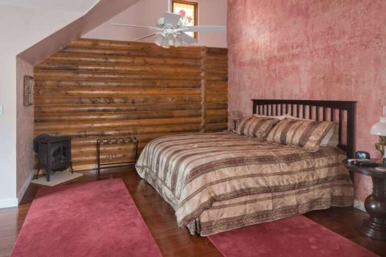 Fourth Bedroom: This elegant room includes a King-sized bed, faux-painted walls, and a bathroom with a claw-foot tub and separate walk-in shower for a spa-like feel.