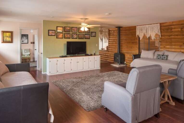 Master Suite: A lavish and exceptionally spacious environment with a King-sized bed, 2 Twin with Trundle beds (Room Sleeps 6), a massage chair, and a dedicated office workspace.