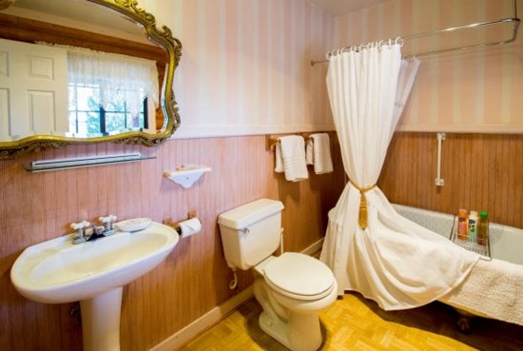 Relax in Comfort and Luxury: Sleep soundly on a cozy queen bed with pastel embroidery and plush pillows, then unwind in a private claw-foot tub for the ultimate relaxation.