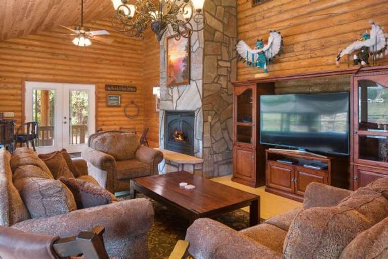 This stunning log cabin lodge, adorned with Native American decor, offers chef's kitchen, and fireplaces throughout, perfect for up to 16 guests.
