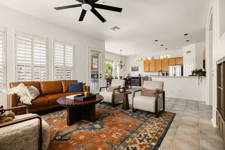 Sun-filled desert modern living. Featuring vaulted ceilings, warm leather accents, and curated textures throughout, this open-concept space blends comfort and style effortlessly.