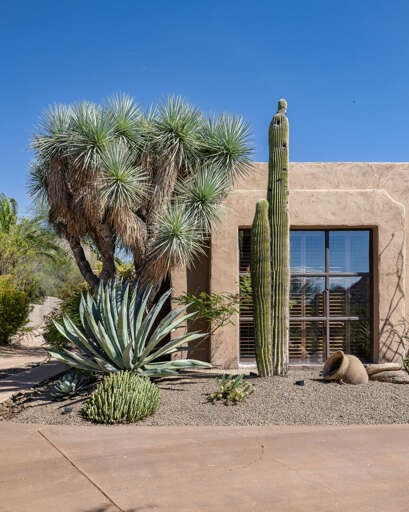 Admire the home's timeless Southwestern architecture, surrounded by native cacti, mature landscaping, and handcrafted design details.