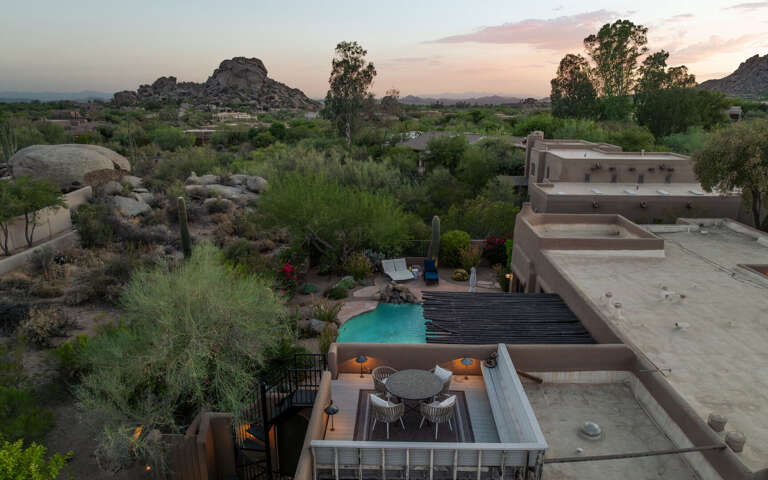 An aerial perspective highlights the private rooftop deck, resort-style pool, and beautifully landscaped outdoor living spaces.