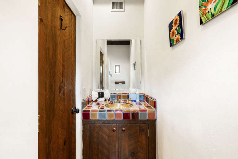 The attached ensuite offers handcrafted tile, custom cabinetry, and plenty of space, providing comfort and convenience for guests.