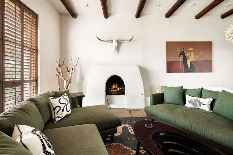 This beautifully designed living room blends authentic Southwestern architecture with plush seating and timeless luxury finishes.
