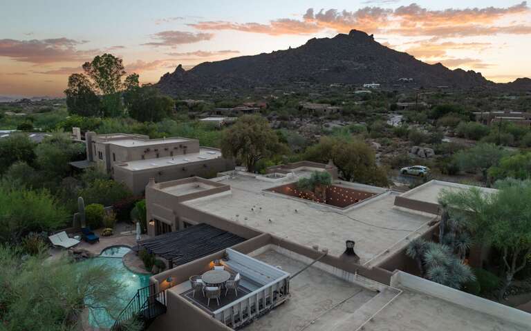 Take in breathtaking sunset views as the home blends seamlessly into the surrounding desert landscape and dramatic mountain backdrop.