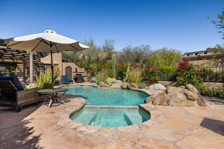 Cool off in the sparkling pool or soak in the spa while surrounded by vibrant desert landscaping and peaceful outdoor living spaces.