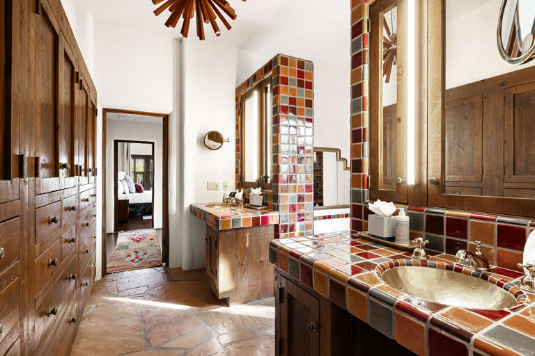 Enjoy generous counter space, custom cabinetry, artisan tile, and elegant finishes throughout this beautifully designed primary bathroom.