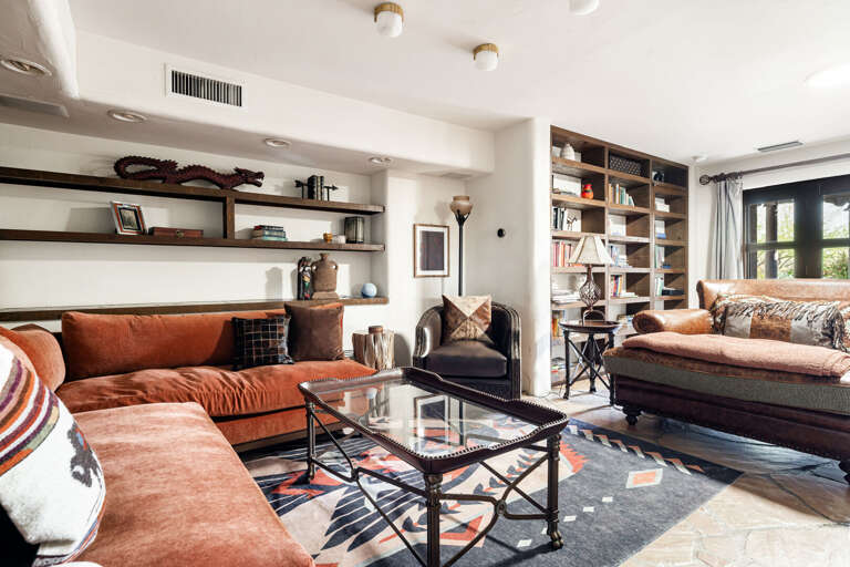 Enjoy open-concept living with generous seating, custom shelving, and seamless access to the home's kitchen and entertaining spaces.