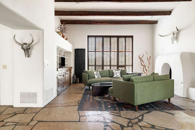 Enjoy spacious open-concept living with rustic wood beams, handcrafted details, and comfortable seating perfect for relaxing together.