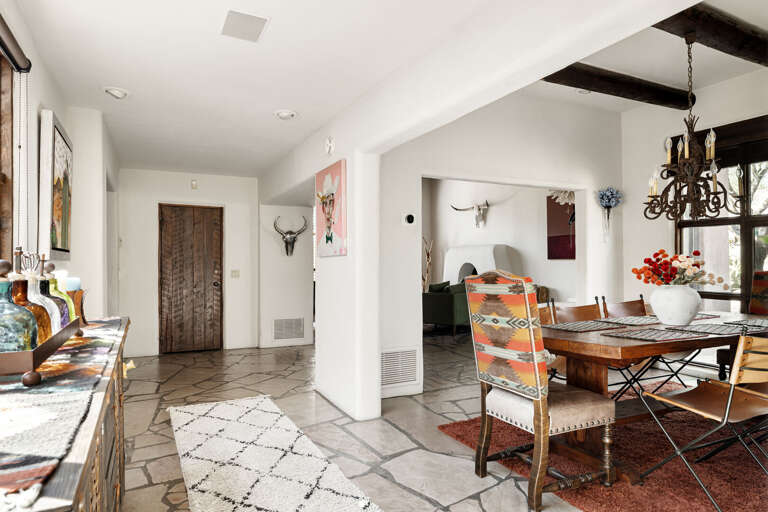 Gather around the beautiful dining table for memorable meals in a warm, inviting space designed for family and friends.