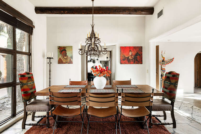 Host family dinners or celebrations around the spacious dining table beneath a stunning chandelier in this inviting gathering space.