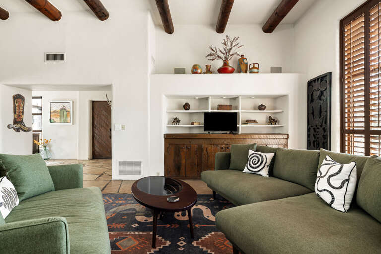 Kick back in the inviting living room featuring plush seating, built-in shelving, and a cozy atmosphere perfect for relaxing after a day of adventure.