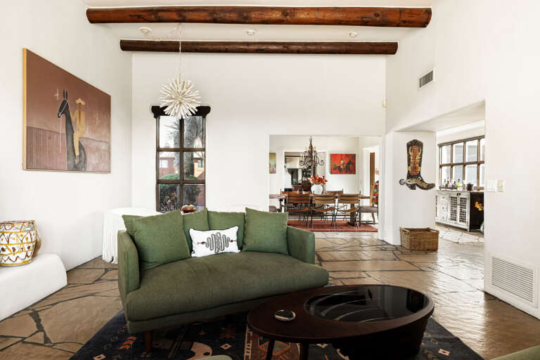 The open-concept great room seamlessly connects the living, dining, and entertaining spaces with timeless Southwestern elegance.