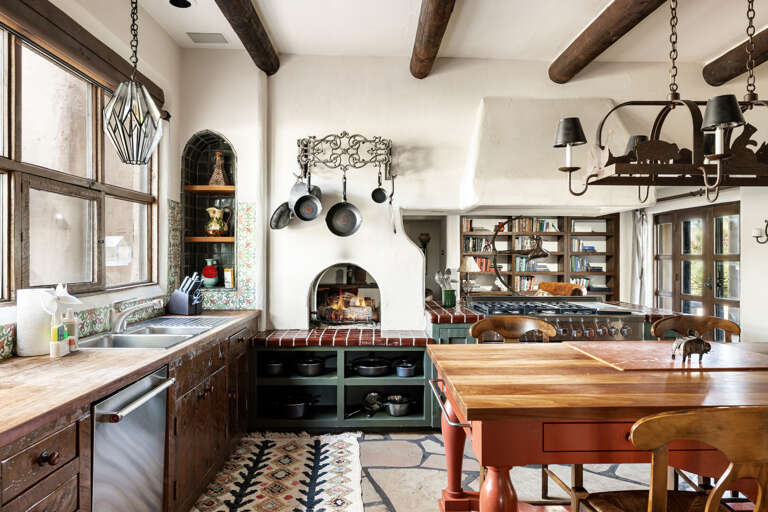 Prepare memorable meals in this gourmet kitchen featuring handcrafted details, premium appliances, and a warm Southwestern atmosphere.