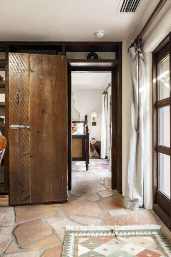 Pull open the custom bookcase to reveal a hidden bedroom, one of the home's most unique architectural features and a favorite surprise for guests.