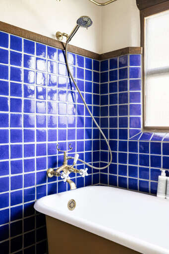 Refresh in the ensuite's beautifully tiled shower, showcasing artisan craftsmanship and classic Southwestern design.