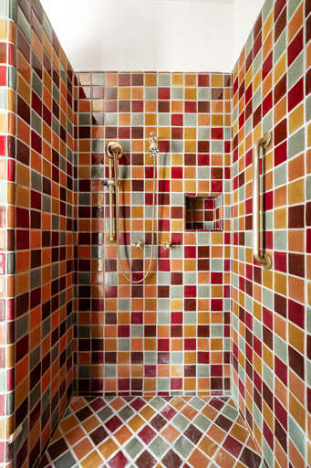 Refresh in the oversized walk-in shower, beautifully finished with colorful handcrafted tile and premium fixtures.