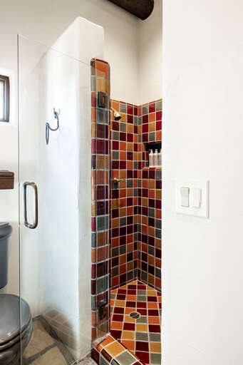 Refresh in the private ensuite's walk-in shower, beautifully finished with handcrafted tile and modern fixtures for a spa-like experience.