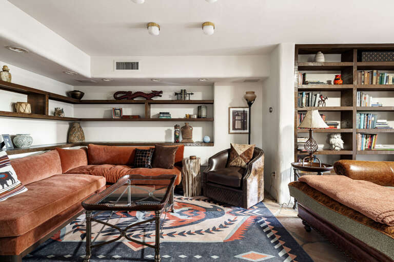 Relax in the cozy family room with plush seating, custom built-ins, and plenty of space to gather for conversation or movie nights.