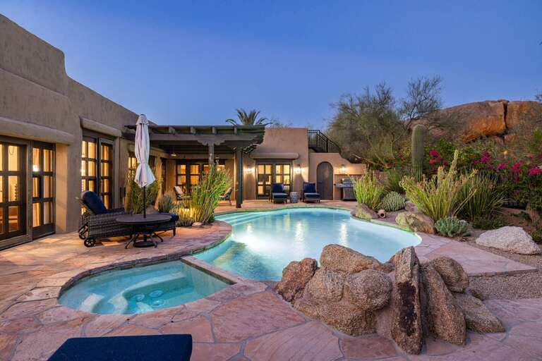 Relax poolside with stunning desert views and a private spa.