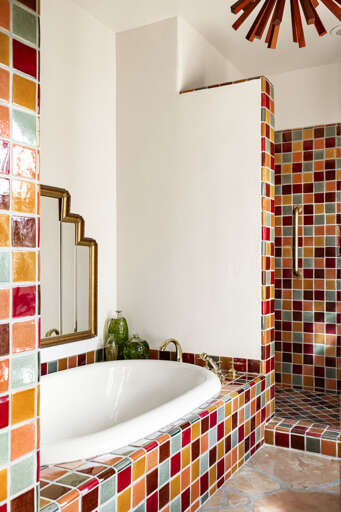 Relax in the soaking tub surrounded by artisan tilework, blending timeless Southwestern design with luxurious comfort.