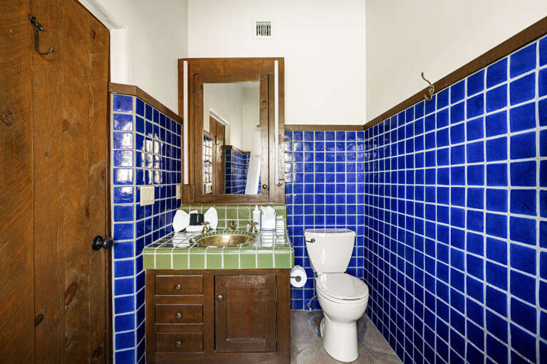 A spacious guest suite with custom built-ins, a comfortable queen bed, and direct access to its private ensuite bathroom.