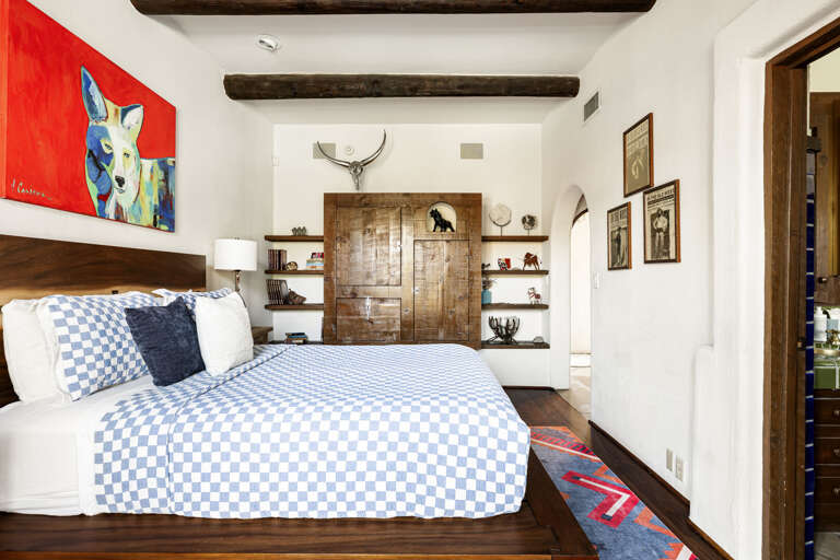 A spacious guest suite with custom built-ins, a comfortable queen bed, and direct access to its private ensuite bathroom.