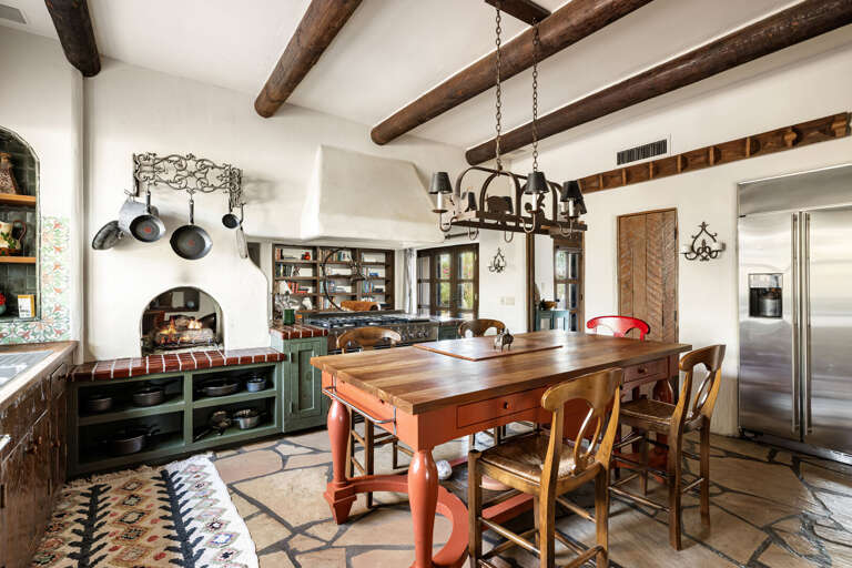 The spacious kitchen offers an oversized island, plenty of seating, and an open layout designed for cooking, dining, and conversation.