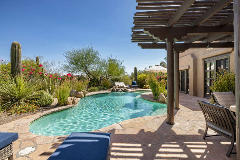 Spend the day lounging beside the sparkling pool, surrounded by lush desert landscaping, shaded patios, and peaceful mountain views.