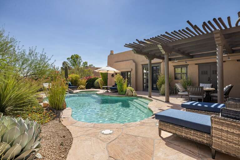 Spend sunny afternoons by the private pool with comfortable lounge seating, beautiful landscaping, and a peaceful desert setting.