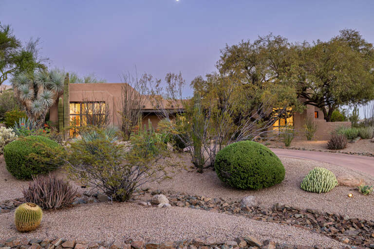 Surrounded by mature desert landscaping, the home's timeless Southwestern architecture blends beautifully into its peaceful natural setting.