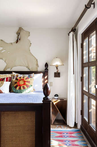 Tucked behind the secret bookcase, this inviting bedroom offers a peaceful retreat with rustic charm and comfortable accommodations.