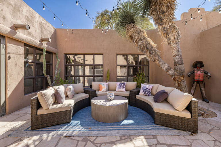 Unwind in the intimate courtyard with plush seating, café lighting, and a cozy atmosphere perfect for morning coffee or evening relaxation.