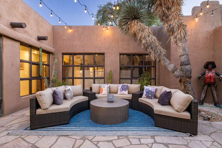 Unwind in the private courtyard with comfortable seating, café lights, and a peaceful setting perfect for morning coffee or evening cocktails.