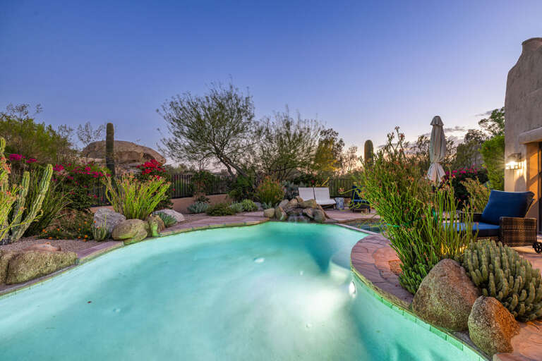 Watch the desert sky glow as you relax by the illuminated pool, creating the perfect setting for peaceful Arizona evenings.