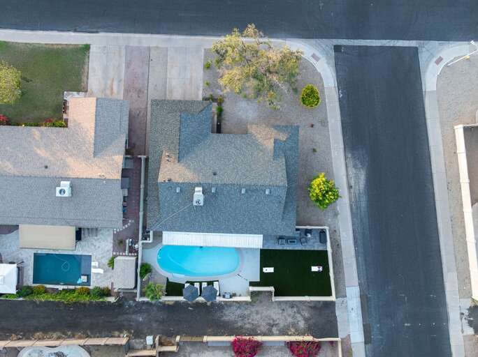 Aerial top-down view of the property showcasing the private pool, outdoor spaces, and spacious backyard layout.