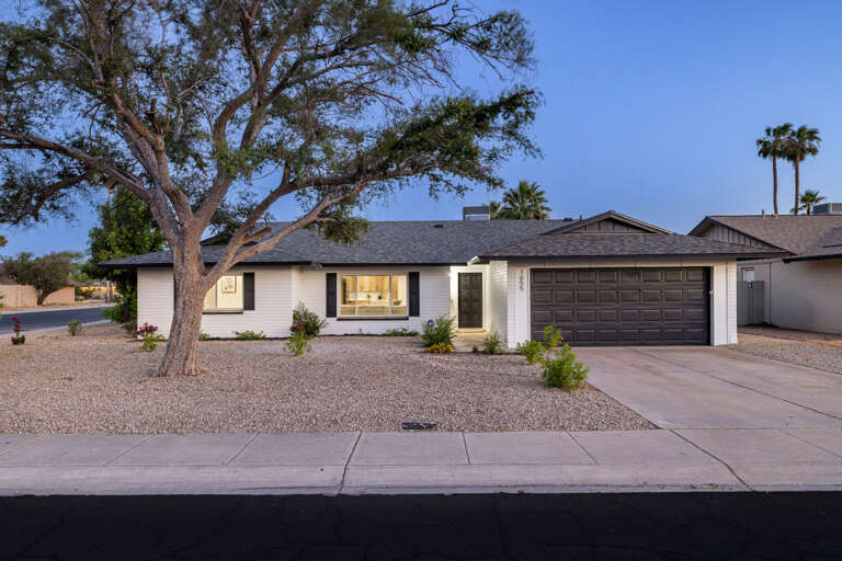 Beautiful exterior view of the home at dusk showcasing modern curb appeal and welcoming outdoor lighting.