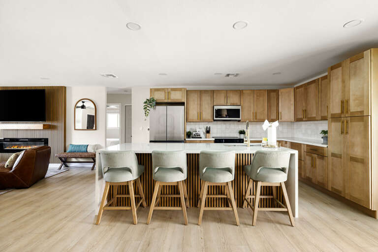 Bright designer kitchen with oversized island seating and stylish contemporary finishes.