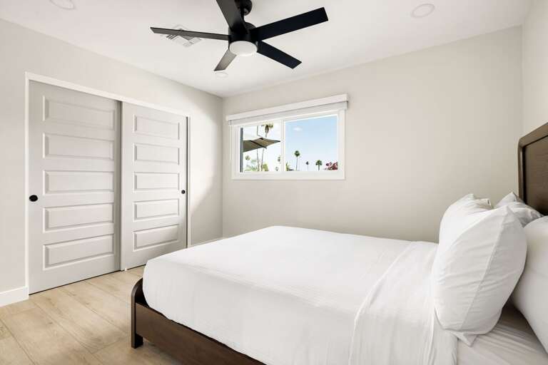 Comfortable bedroom with clean modern décor, natural light, and a relaxing atmosphere.