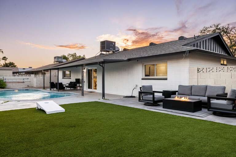 Expansive backyard retreat with lush turf, cozy lounge seating, and a perfect setup for outdoor relaxation.