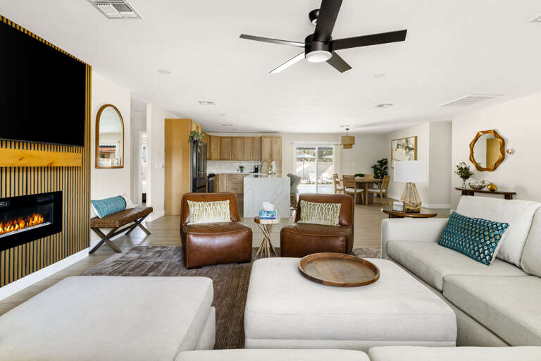 Open-concept living area designed for comfort, featuring ample seating and seamless flow into the kitchen.